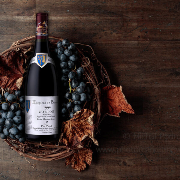 Bottle of red wine Hospices de Beaune 1990 with grapes and dried vine leaves Product photography services Derby